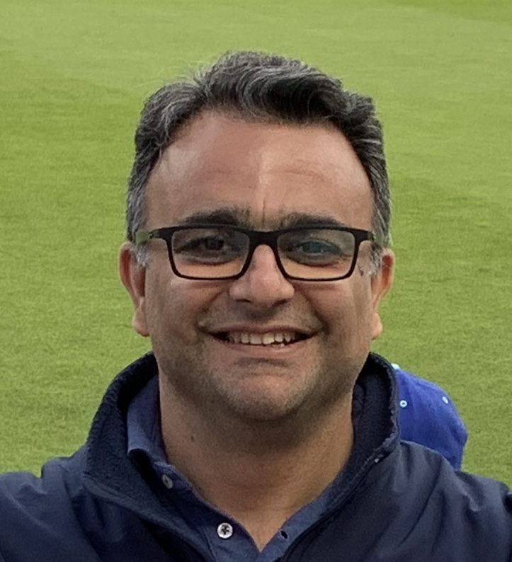 Nuruddin Pethani smiling with green grass background